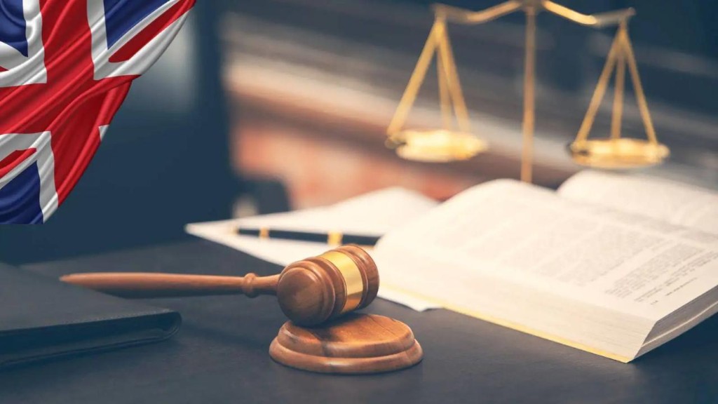 UK justice — gavel, scales and law book with Union Jack